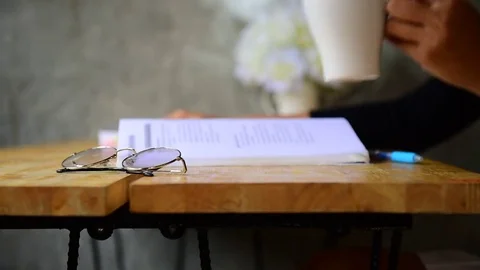 Drink coffee and read a book in a coffee shop. Stock Footage 80411620