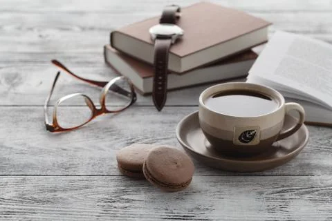 Drink coffee while reading book on table Stock-Fotos