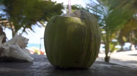 Drink a fresh coconut on the table  Video stock 47784534