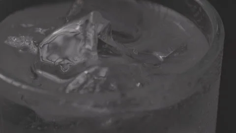 Drink in Glas with Ice, rotating, Black Background, Clog3, Cinema Gamut Stock Footage 241814360