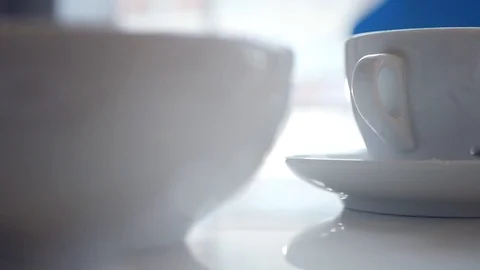 Drink invigorating hot tea in a white cup with steam, camera movement. slow Stock Footage 97505225
