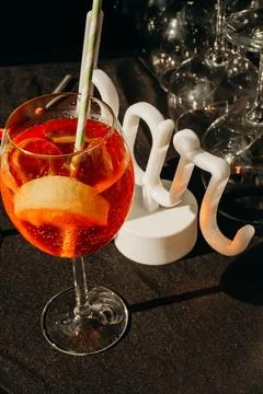 Drink with lemon slice placed on  table at  social event with glassware in th Stock Photos