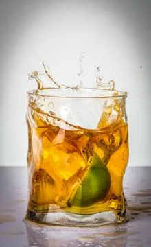 Drink with lime splash Stock Photos