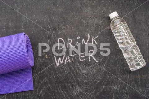 Drink more water - hydration reminder - handwriting on On a chalk board Stock Photos