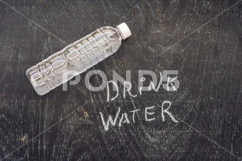 Drink more water - hydration reminder - handwriting on On a chalk board Stock Photos