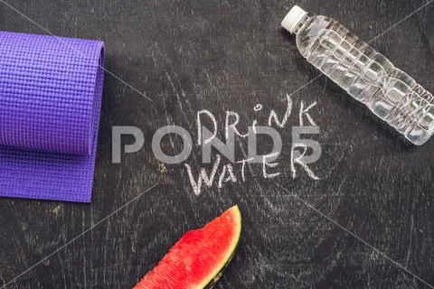 Drink more water - hydration reminder - handwriting on On a chalk board Stock Photos