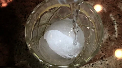 DRINK POURED ON ROUND ICE CUBE Video stock 52594840