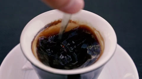 Drink. Sugar is mixed in a cup of coffee. Stock Footage 166868170