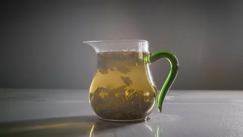 Drink timelapse of a cup of strong tea steeped in boiling water sinking Stock Footage 320094334