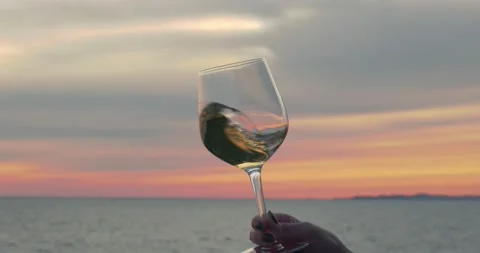 Drinking and tasting wine in sunset at sea 스톡 동영상 153534706