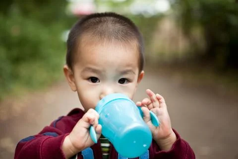 Drinking asian boy Stock Photos