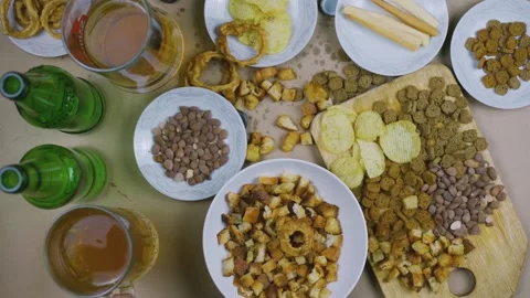 Drinking beer. Table full of beer snacks Stock Footage 132354411