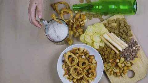 Drinking beer. Table full of beer snacks Stock Footage 132354521