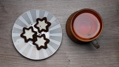 Drinking of black tea from a teacup on a white background and white plate wit Stock-Footage 107208967