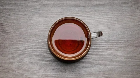 Drinking of black tea from a teacup on a white background - Stop motion. TIME Stock-Footage 107224679