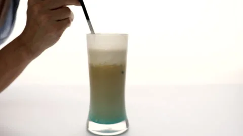 Drinking blue latte in glass cup with colorful layers Stock Footage 137162798