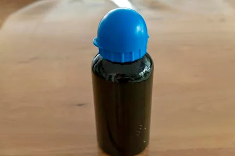 Drinking bottle with blue cap and black bottle with text space Stock Photos