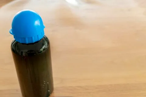 Drinking bottle with blue cap and black bottle with text space Stock Photos