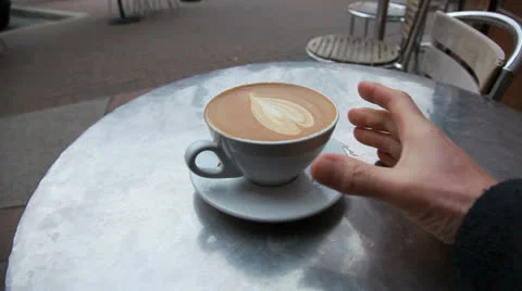 Drinking a cappuccino at an outdoor cafe 動画素材 24516809