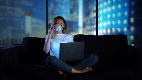Drinking coffee and using laptop in modern home Stock Footage 95096654