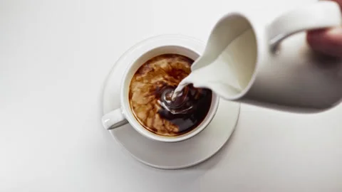 Drinking Coffee Beverage with White Milk from Espresso Cup at Morning Breakfast Stock Footage 236370729