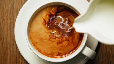 Drinking Coffee Beverage with White Milk from Espresso Cup at Morning Breakfast Stock Footage 240557531