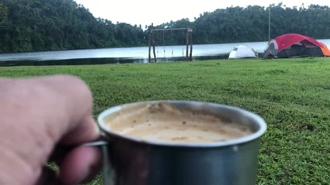 Drinking Coffee Cappuccino during camping by the lake Stock Footage 204978575