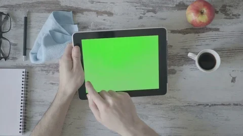 Drinking coffee close up of business man's hand using green screen tablet. Stock Footage 80533361