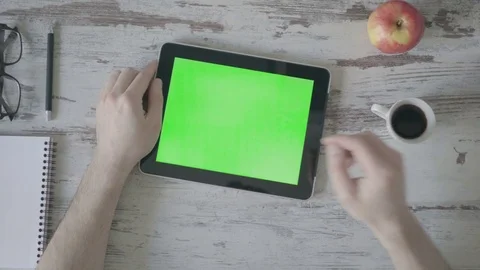 Drinking coffee close up of business man's hand using green screen tablet. Stock Footage 80533479