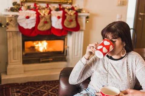Drinking coffee by the fireplace Stock Photos