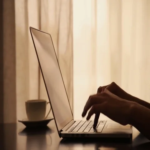 Drinking coffee with laptop Stockbeeldmateriaal 69575039