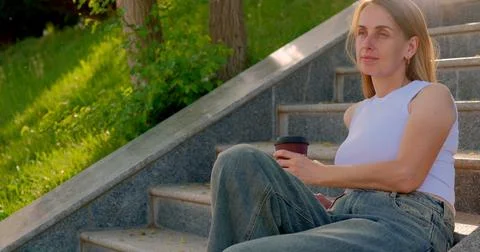 Drinking Coffee on the Steps in the Sunshine Stock Photos