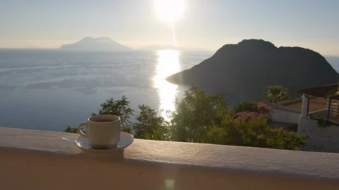 Drinking coffee with view on volcanic island in Mediterranean sea Stock Footage 130142865