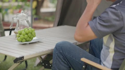 Drinking Coffee While Relaxing at a Backyard Campsite Stock-Footage 346533961