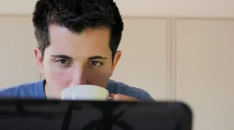 Drinking coffee while you are focused on the computer in the office Stock Footage 60682003