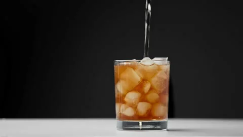 Drinking Coke Beverage or Cold Bubbly Liquid Filling Glass Cup with Ice Cubes Stock Footage 237819566