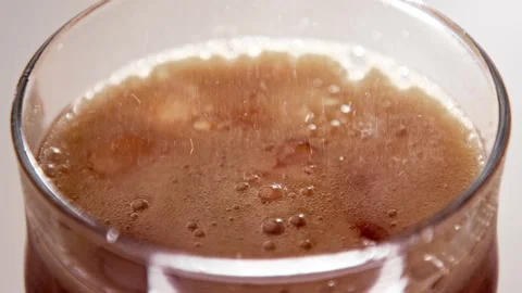 Drinking Coke Beverage or Cold Bubbly Liquid Filling Glass Cup with Ice Cubes Stock Footage 239641702