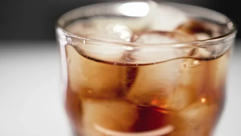 Drinking Coke Beverage or Cold Bubbly Liquid Filling Glass Cup with Ice Cubes Stock Footage 257089075