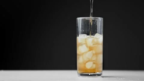 Drinking Coke Beverage or Cold Bubbly Liquid Filling Glass Cup with Ice Cubes Stock Footage 257406404