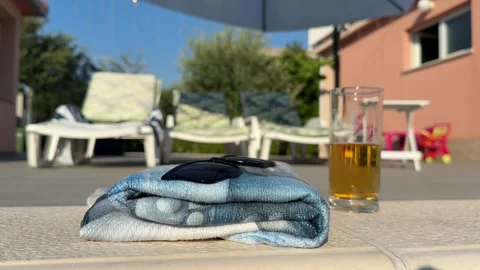 Drinking a cold beer in the pool, sun lounger on the edge of the pool, towe.. 動画素材 339666978
