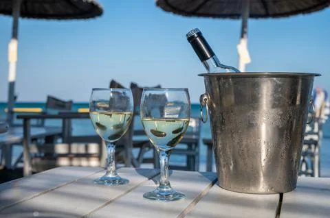 Drinking of cold white wine in beach bar, summer holidays, relax on sandy bea Stock Photos