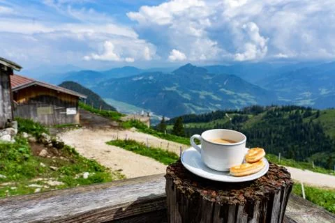 Drinking a cup of caffee with breakfast over the mountains in tyrol on a hut  Stock Photos