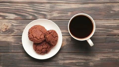 Drinking a cup of coffee and eating choсolate cookie - Stop motion. Stock Footage 135894343