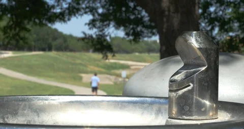 Drinking-Fountain-Guy-in-Background Stock Footage 89776563