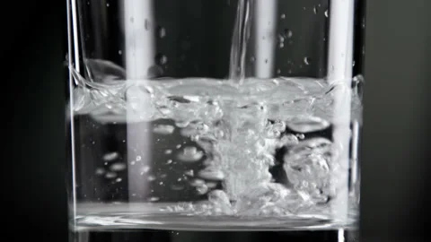Drinking Fresh Water Falling Down into Clear Glass Cup for Healthy Lifestyle Stock Footage 237458464