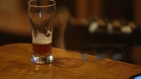 Drinking a glass of beer and playing guitar Stock Footage 132054549