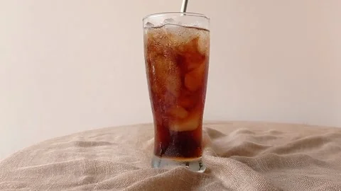 Drinking a glass of cold cola with a straw Stock Footage 146251301