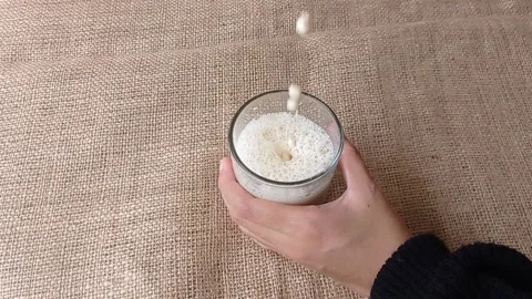 Drinking a glass of fresh milk on the table Stock Footage 150399495