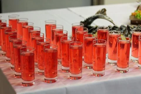 Drinking glasses with red drinks at the party Stock Photos