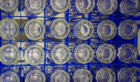 Drinking glasses was placed upside down in a blue plastic box Stock Photos